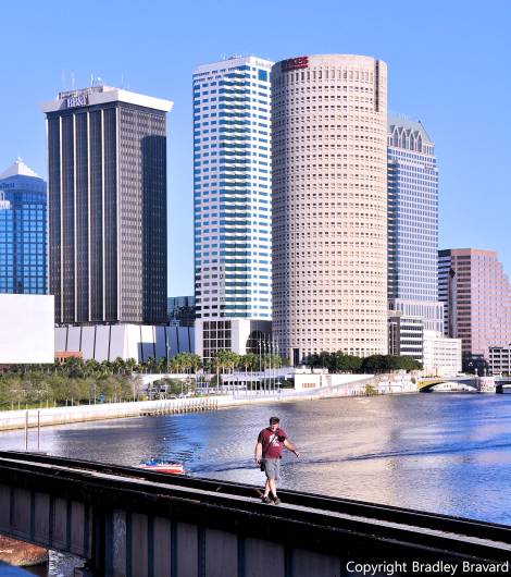 Photo of Tampa, Florida, skyline with person walking on bridge in foreground