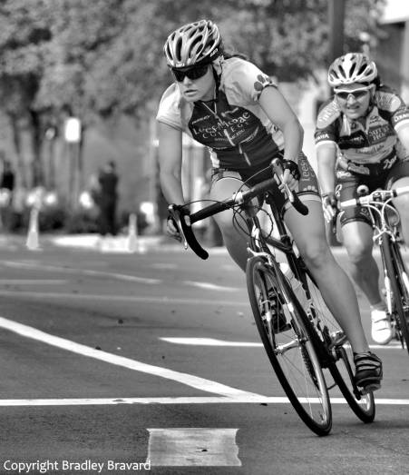 Black and white photo of two women on bicycles