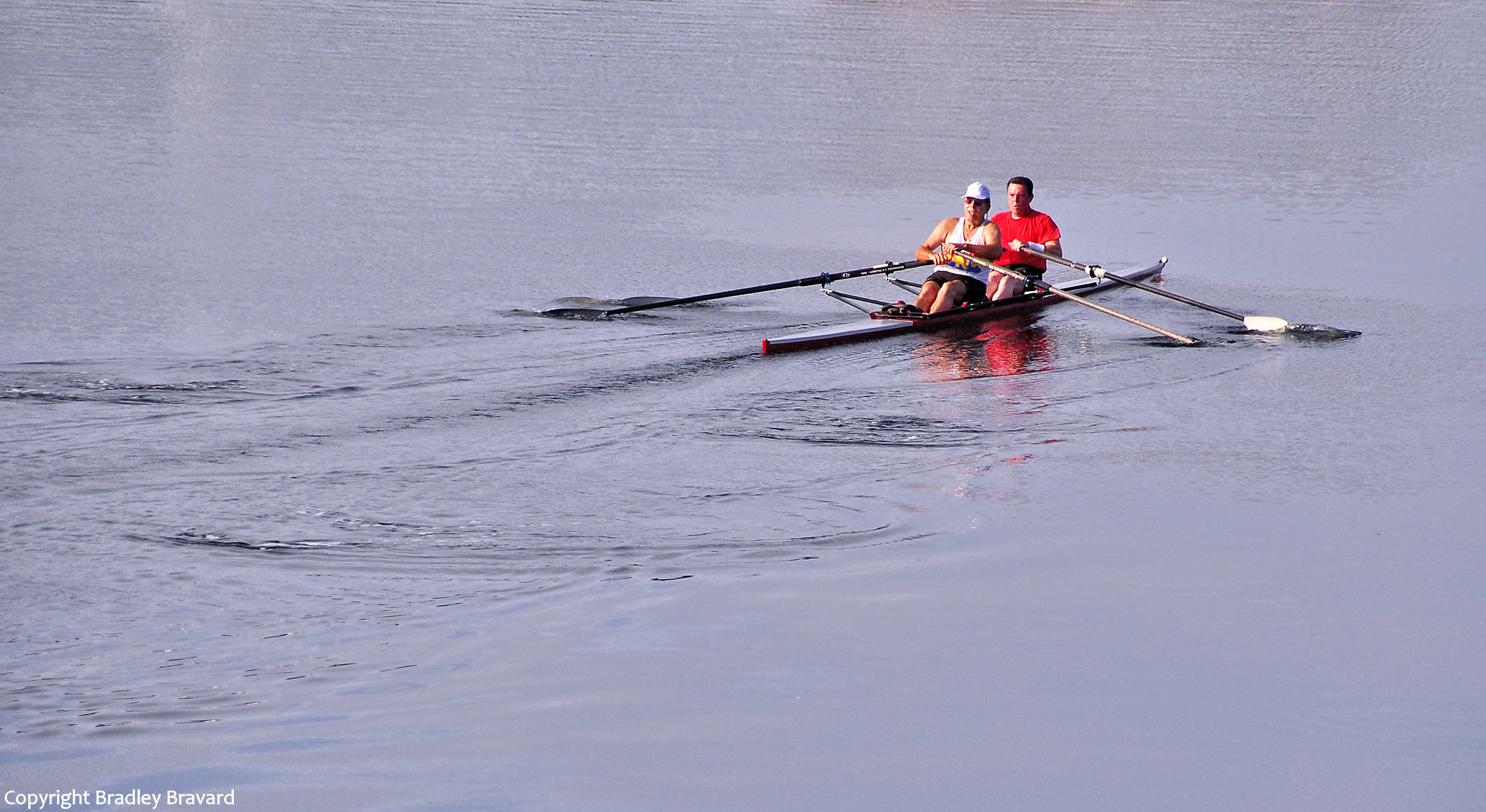 Photo of two men rowing a kayak on a river