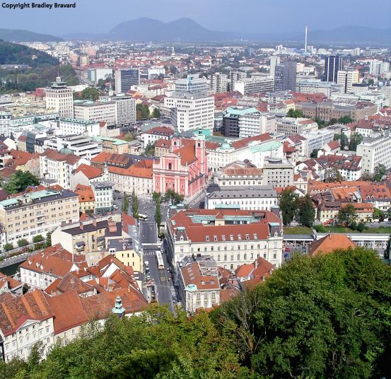Color photo of central Ljubljana, Slovenia, viewed from Ljubljana Castle, highlighting Preseren Square and the Franciscan Church of the Annunciation