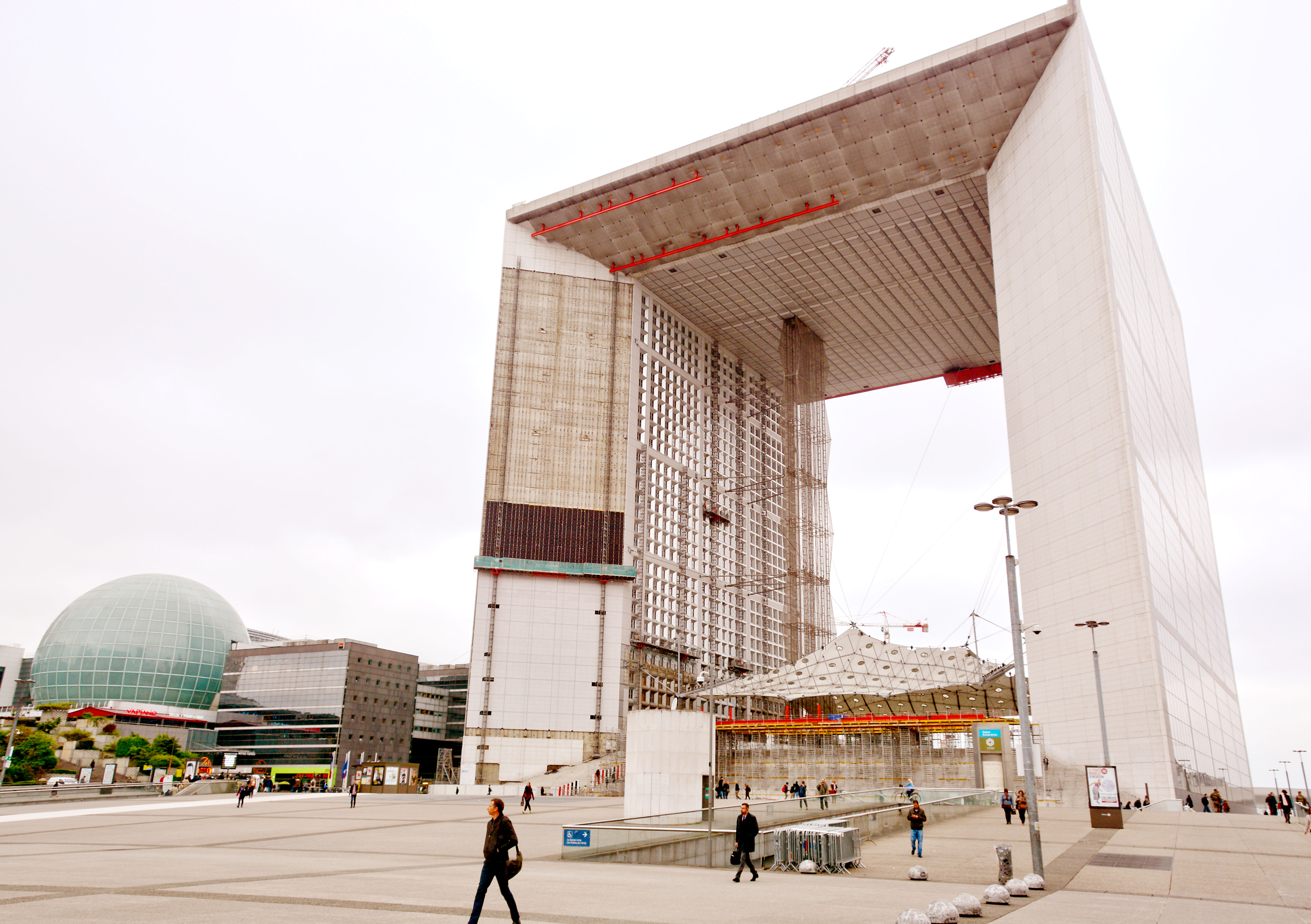 La Grande Arche in La Defense area of Paris, with pedestrian in foreground