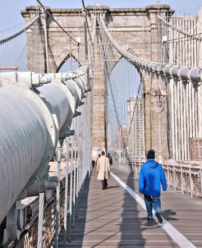Pedestrian path on Brooklyn Bridge showing detail of suspension cable leading to bridge tower