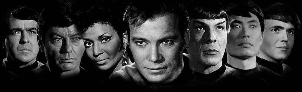 Black and white photo of original Star Trek cast members showing, left to right, James Doohan, DeForest Kelley, Nichelle Nichols, William Shatner, Leonard Nimoy, George Takei, and Walter Koenig