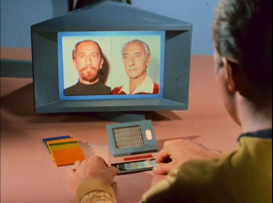Image from Star Trek episode The Conscience of the King showing Kirk looking at photos of younger and older Karidian