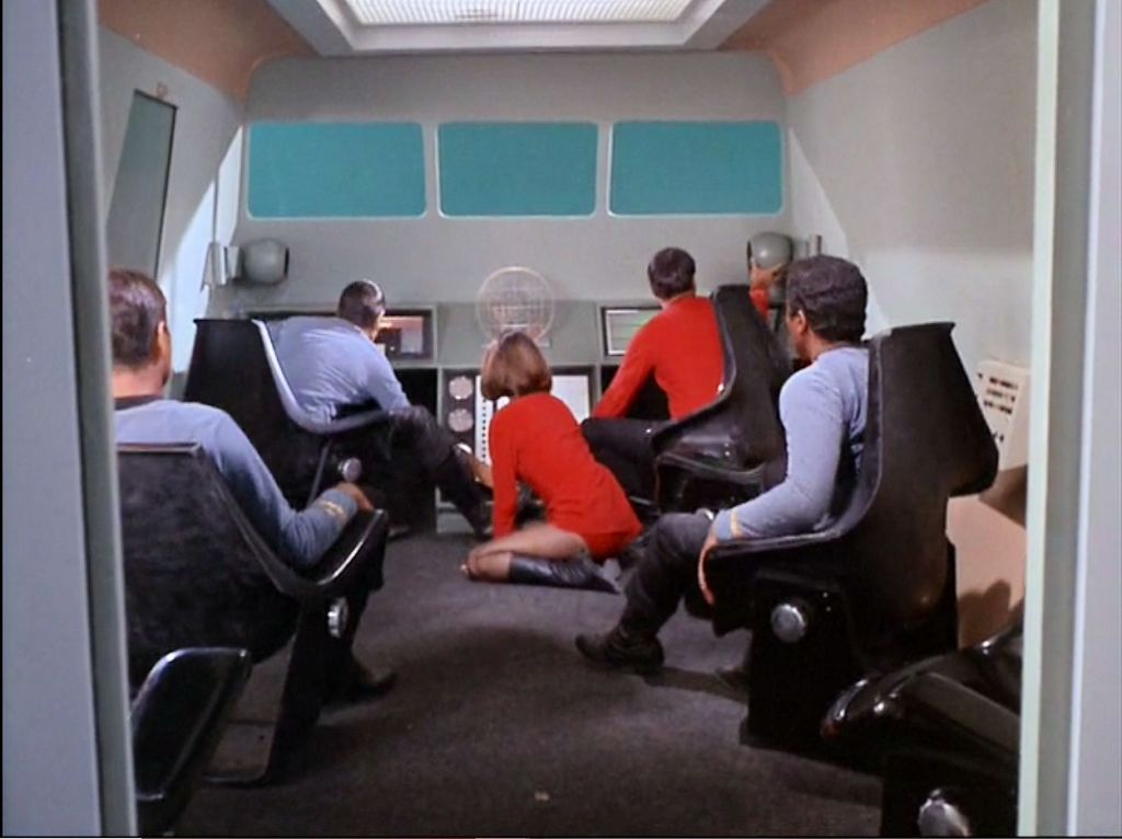 Image from Star Trek episode The Galileo Seven with Yeoman Mears on floor of shuttlecraft and male crew members in chairs